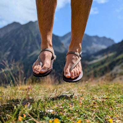 Man jumping with barefoot sandals out in nature - zuzu barefoot