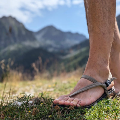 Man with barefoot sandals out in nature with mountains behind - zuzu barefoot